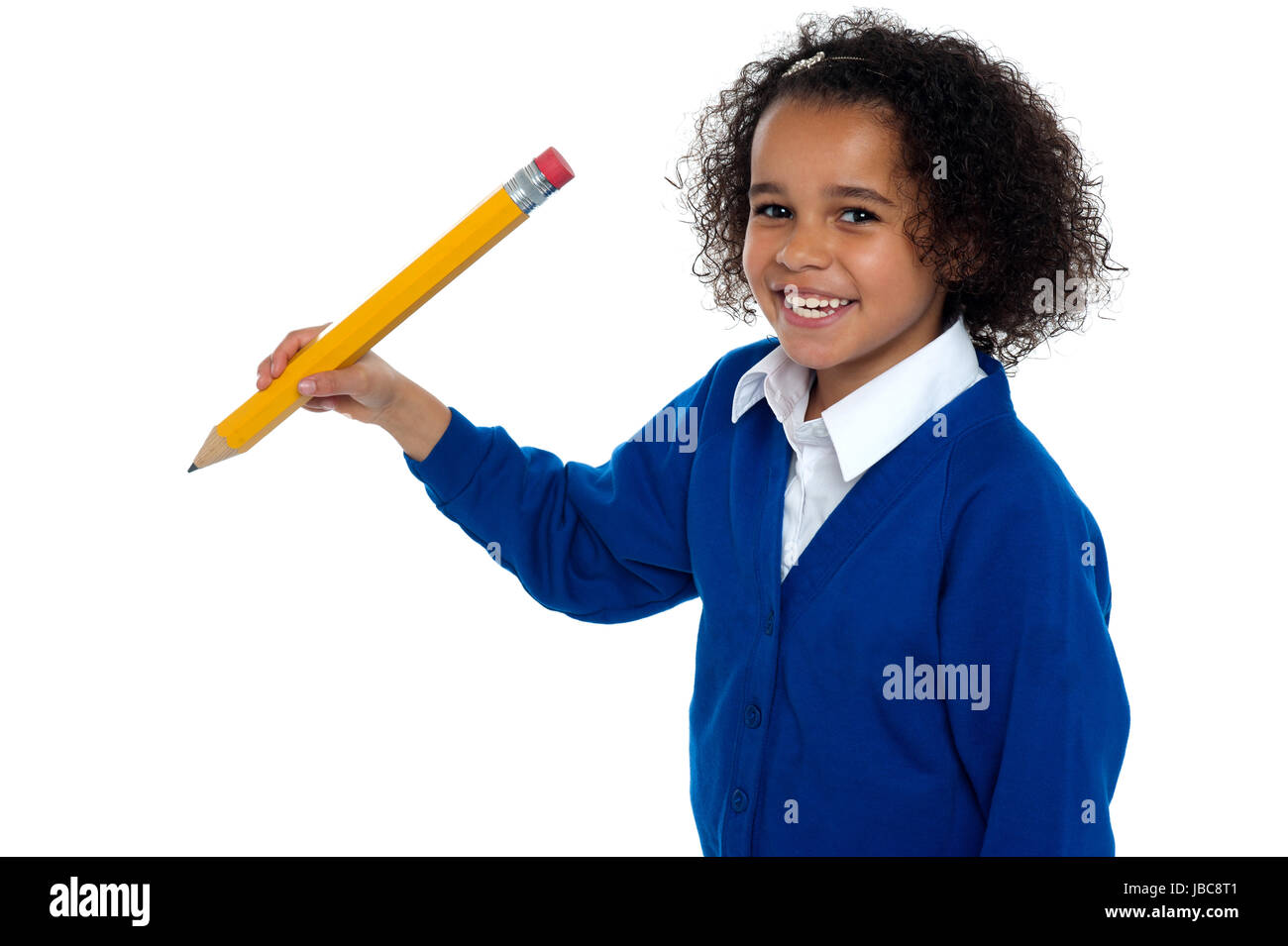 Lovely elementary girl facing the camera with a pencil in hand ...