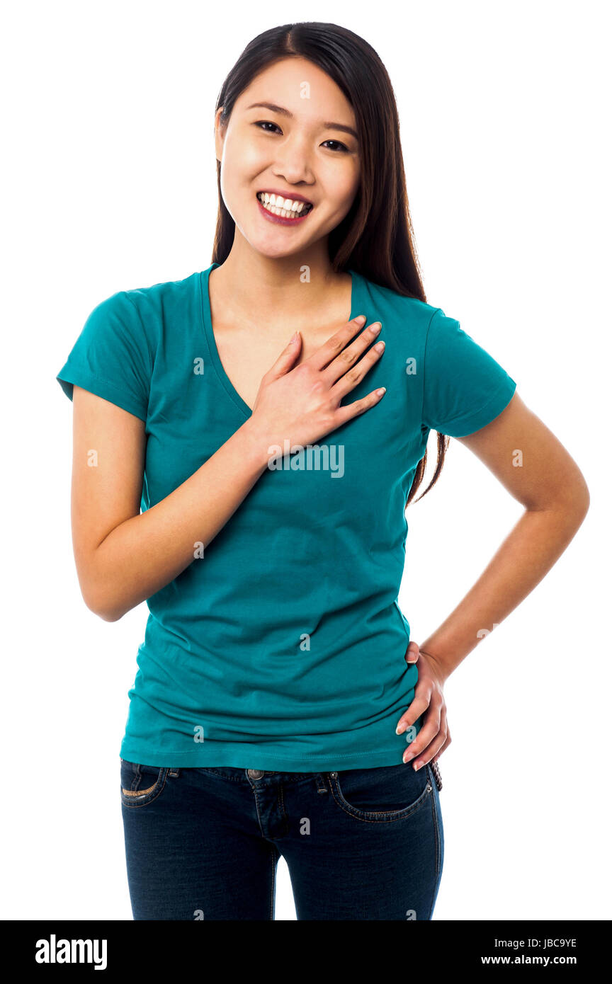 Portrait of a casual pretty girl resting arm across her chest Stock