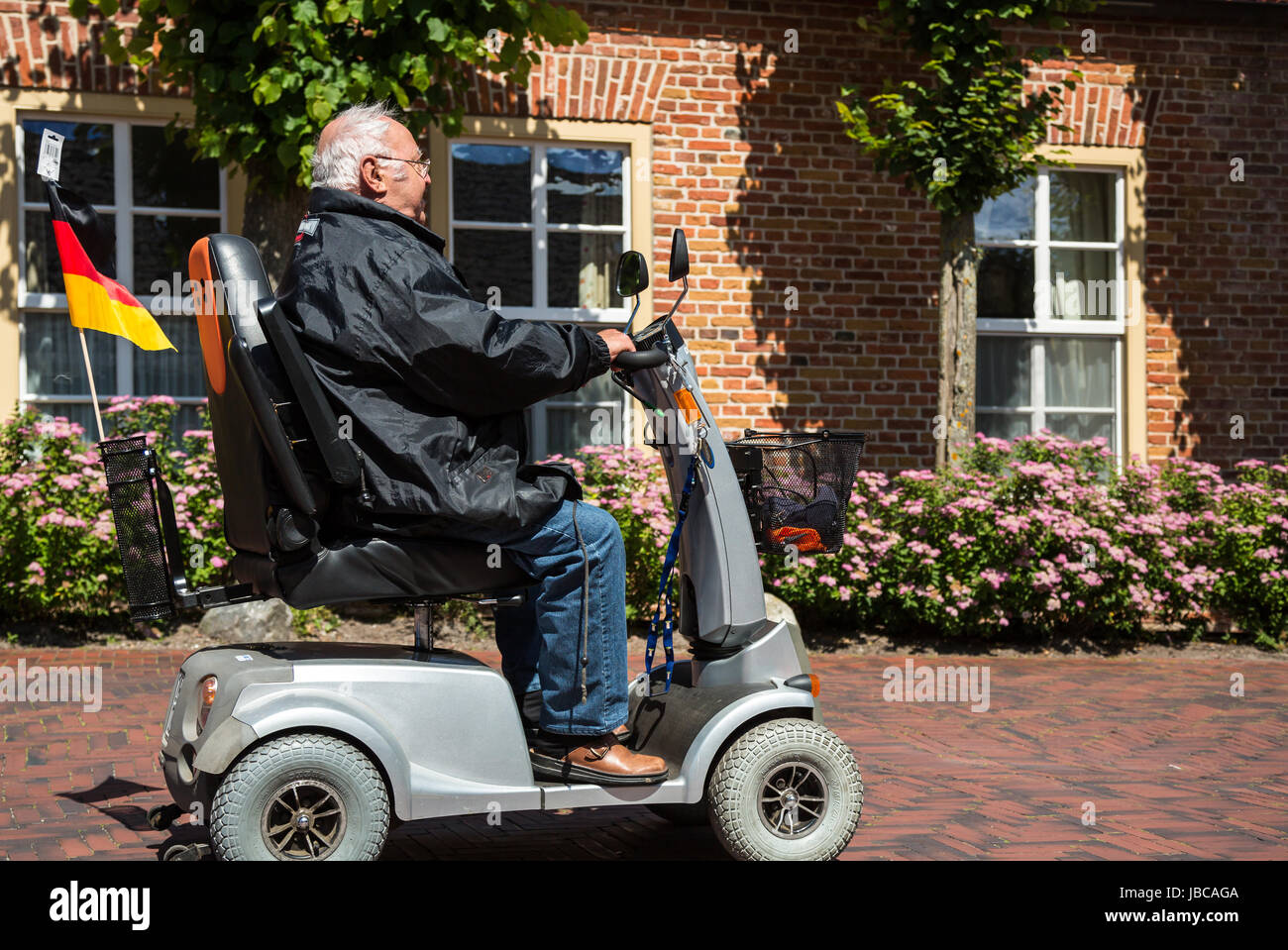 Greetsiel, Germany, a man traveling with an electric car Stock Photo