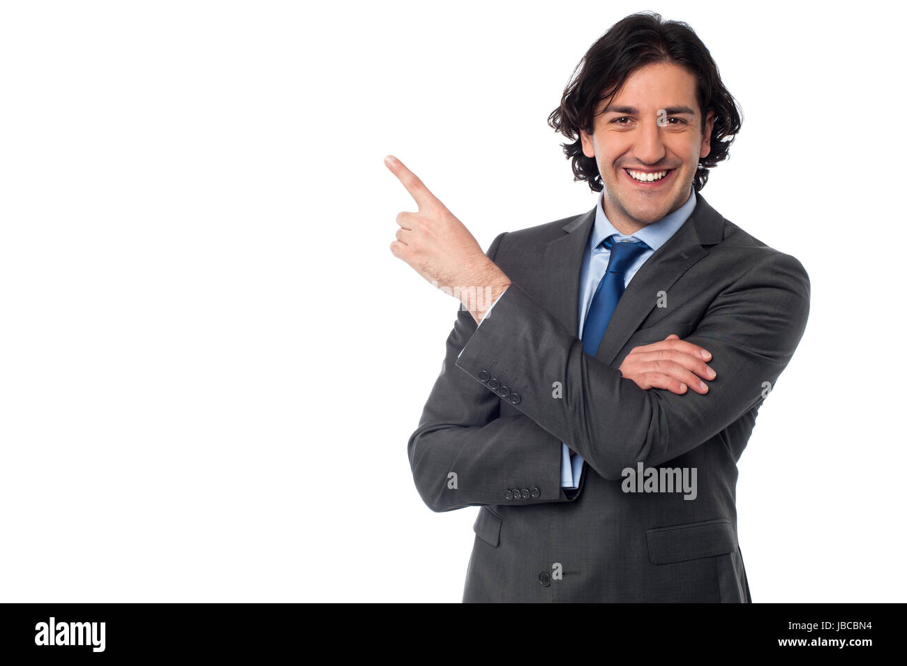 Smart male executive pointing towards copy space area Stock Photo - Alamy