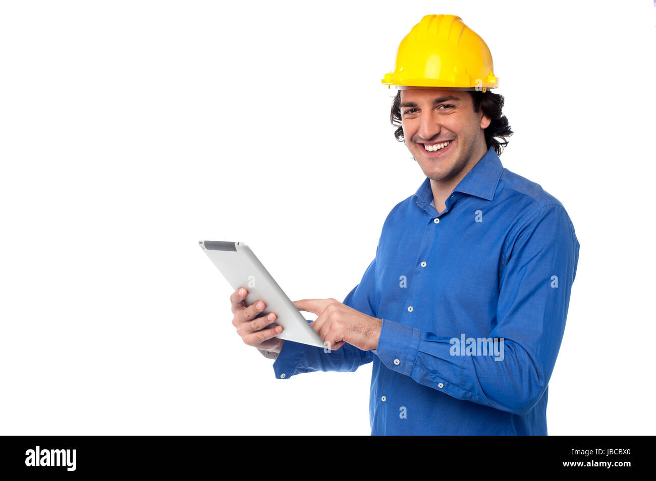 Young construction worker operating touch pad device Stock Photo - Alamy