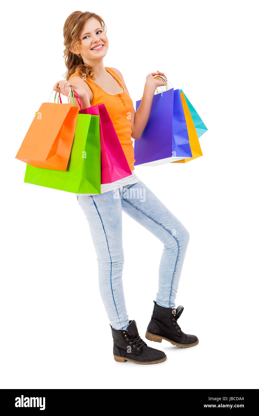 junge attraktive lachende frau auf shopping tour mit bunten einkaufstaschen isoliert Stock Photo