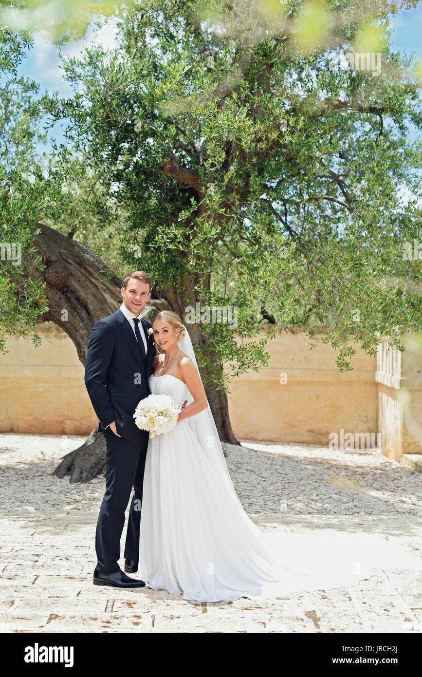 HANDOUT - A handout picture made available on 09 June 2017 shows German soccer national player and German Bundesliga goalkeeper of the FC Bayern Munich, Manuel Neuer, and his wife Nina Neuer (née Weiss) shortly after the church wedding in Monopoli, Italy, 09 June 2017.   (ATTENTION EDITORS: FOR EDITORIAL USE ONLY IN CONNECTION WITH CURRENT REPORTING/ MANDATORY CREDIT) · NO WIRE SERVICE · Photo: Pia Clodi/peachesandmint.com/dpa Stock Photo