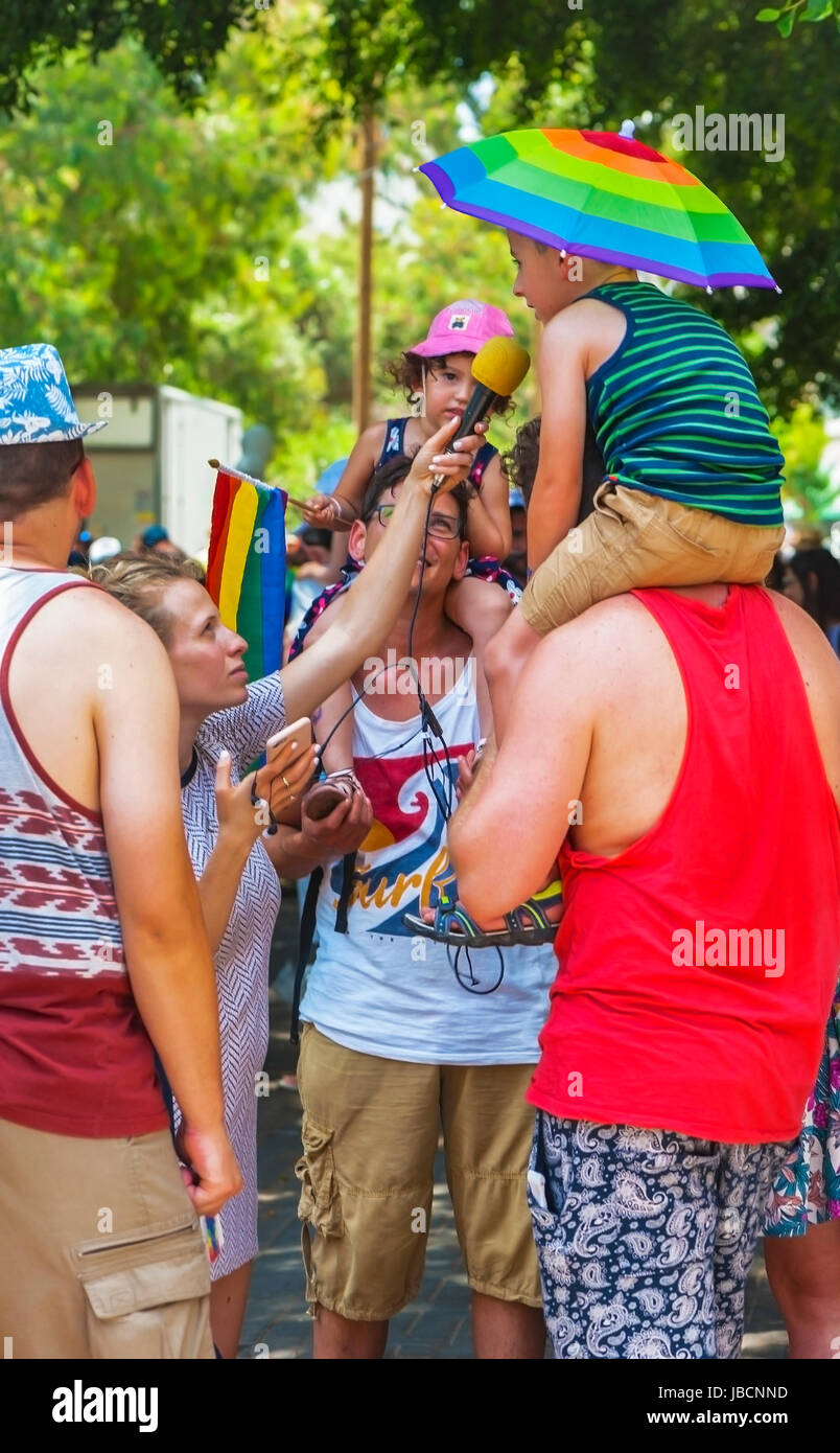 Tel Aviv, Israel. 9th June, 2017. gay couple with children giving interview at Gay Parade Credit: Yuri Turkov/Alamy Live News Stock Photo