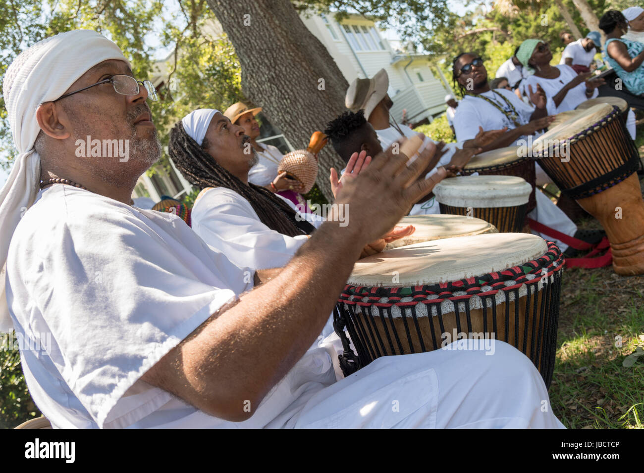 Charleston, South Carolina, USA. 10th June, 2017. Descendants of enslaved Africans brought to Charleston in the Middle Passage hold a drum circle to honor their relatives lost during a remembrance ceremony at Fort Moultie National Monument June 10, 2017 in Sullivan's Island, South Carolina. The Middle Passage refers to the triangular trade in which millions of Africans were shipped to the New World as part of the Atlantic slave trade. An estimated 15% of the Africans died at sea and considerably more in the process of capturing and transporting. Credit: Planetpix/Alamy Live News Stock Photo