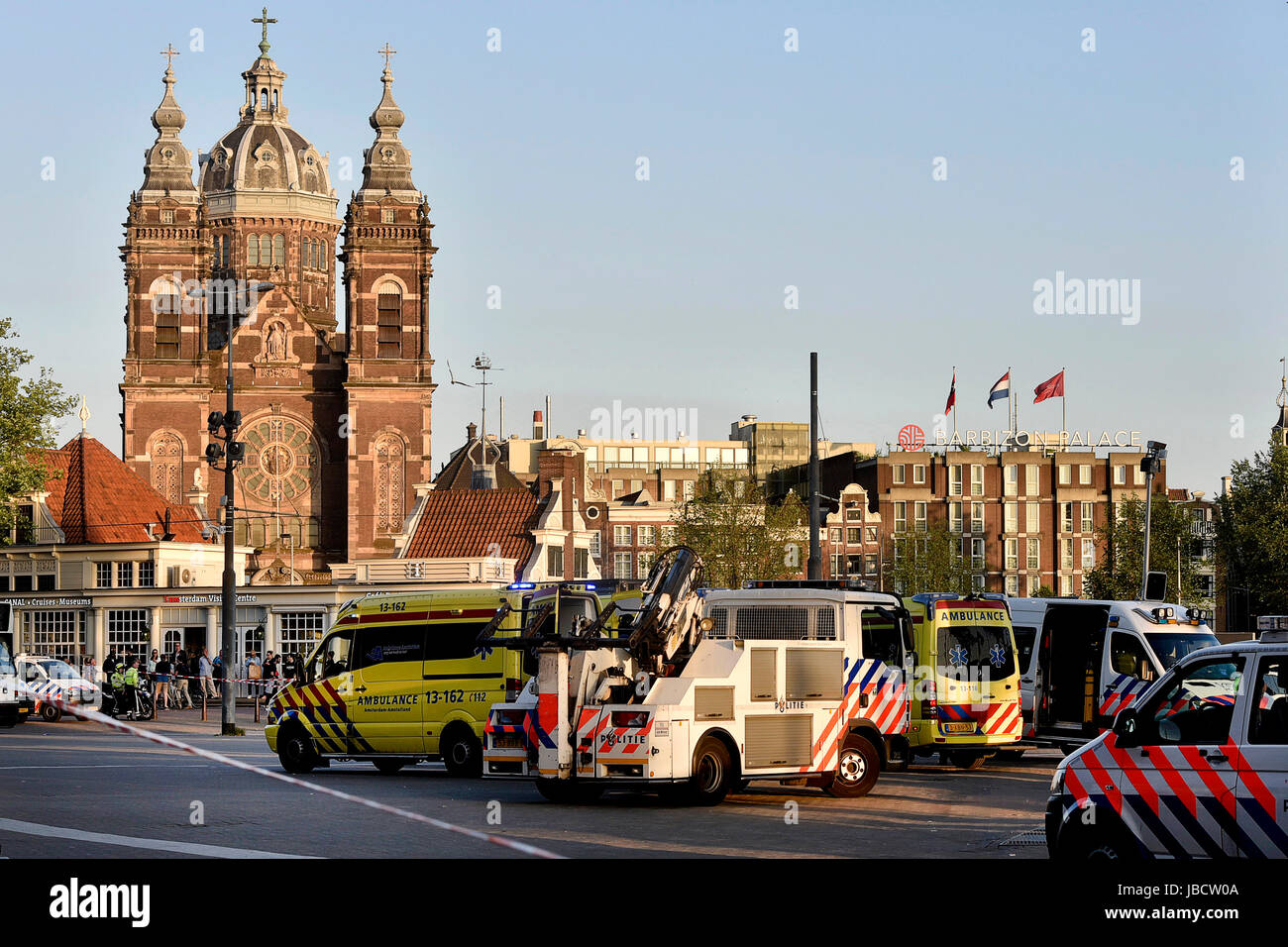 Amsterdam, Netherlands. 10th June, 2017. Rescue vehicles stand by at the site of a car crash in Amsterdam, the Netherlands, on June 10, 2017. In front of Amsterdam Central Station a car hit pedestrians and crashed against a wall at around 9 p.m. local time, injuring eight people, Amsterdam police said on Saturday. Credit: Rick Nederstigt/Xinhua/Alamy Live News Stock Photo