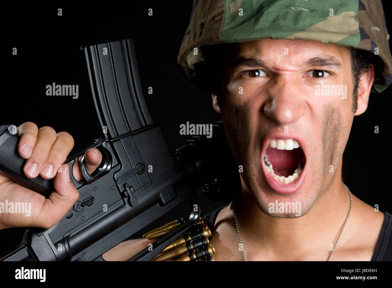 Angry military soldier holding gun Stock Photo