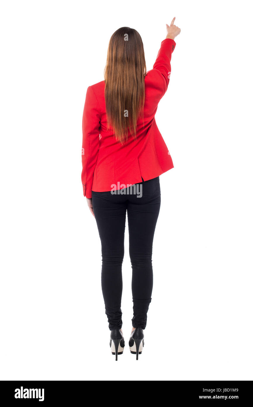 Rear view of a woman in red blazer pointing towards to the wall Stock ...