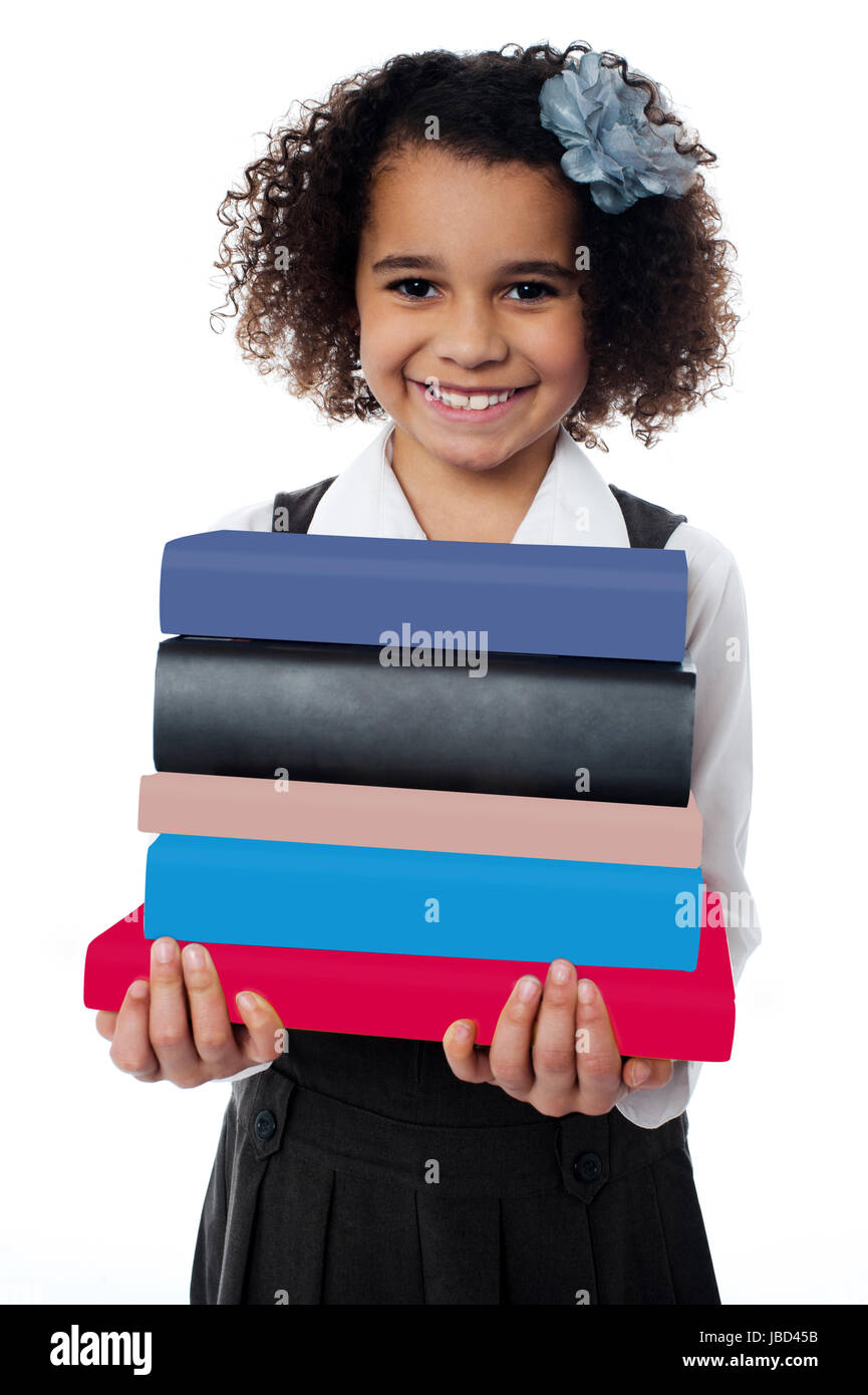 Isolated little girl carrying pile of books Stock Photo - Alamy