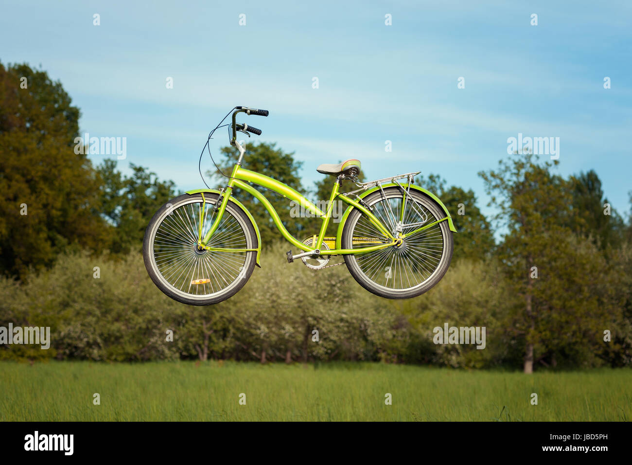 Bike levitates in the park over the meadow. Stock Photo