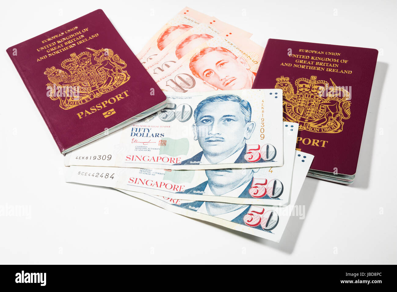 Singapore Dollars and UK Passports Stock Photo
