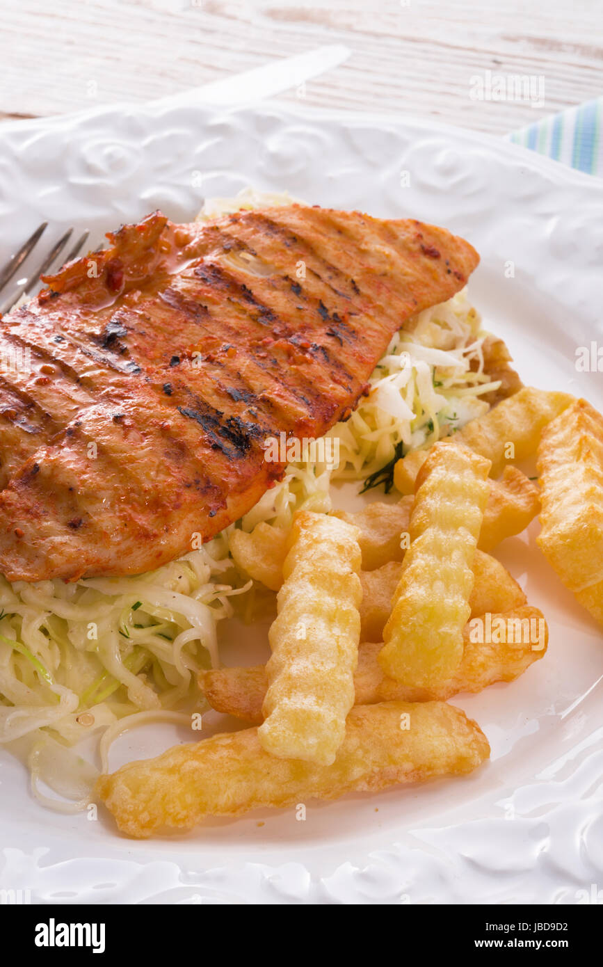 grilled chicken, cabbage salad with nuts and chips Stock Photo