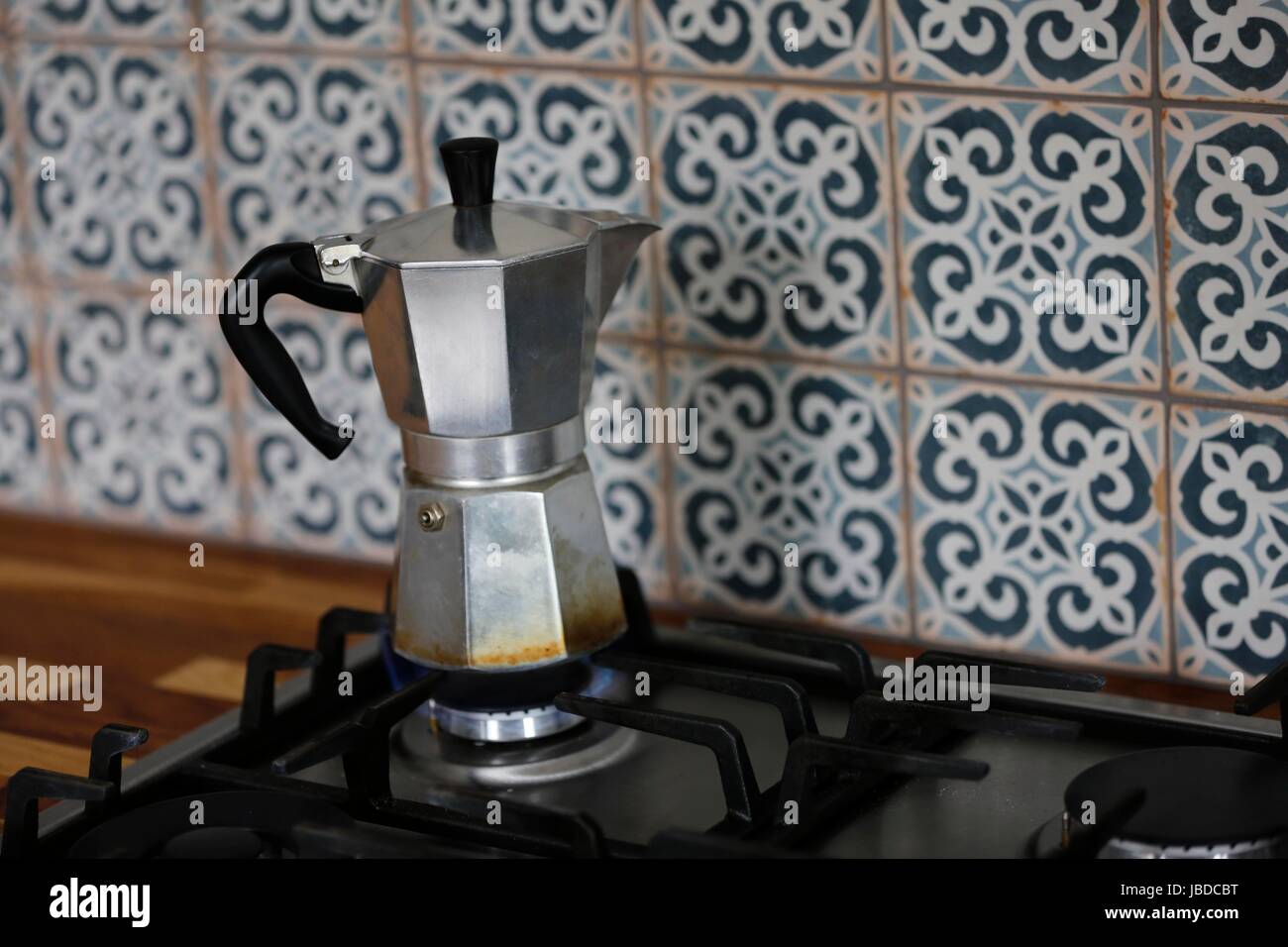 A Bialetti Moka Express Coffee maker brewing fresh coffee on a gas cooking  hob Stock Photo - Alamy