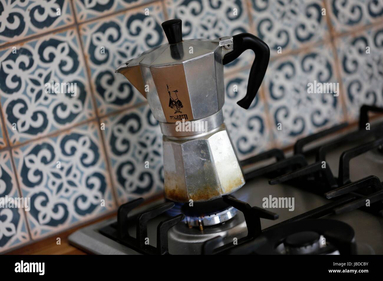 A Bialetti Moka Express Coffee maker brewing fresh coffee on a gas
