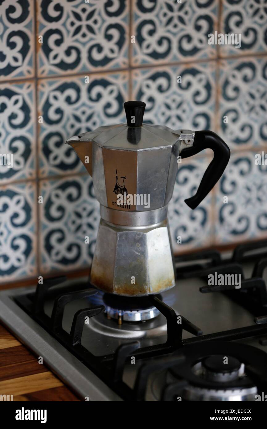 A Bialetti Moka Express Coffee maker brewing fresh coffee on a gas cooking  hob Stock Photo - Alamy