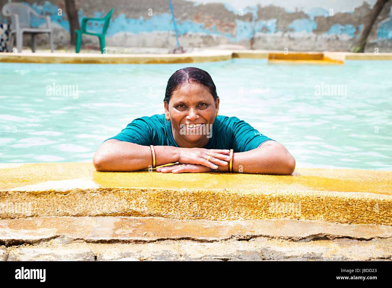 Senior Woman Swimming Pool Standing Ledge Relaxed In Waterpark Stock Photo