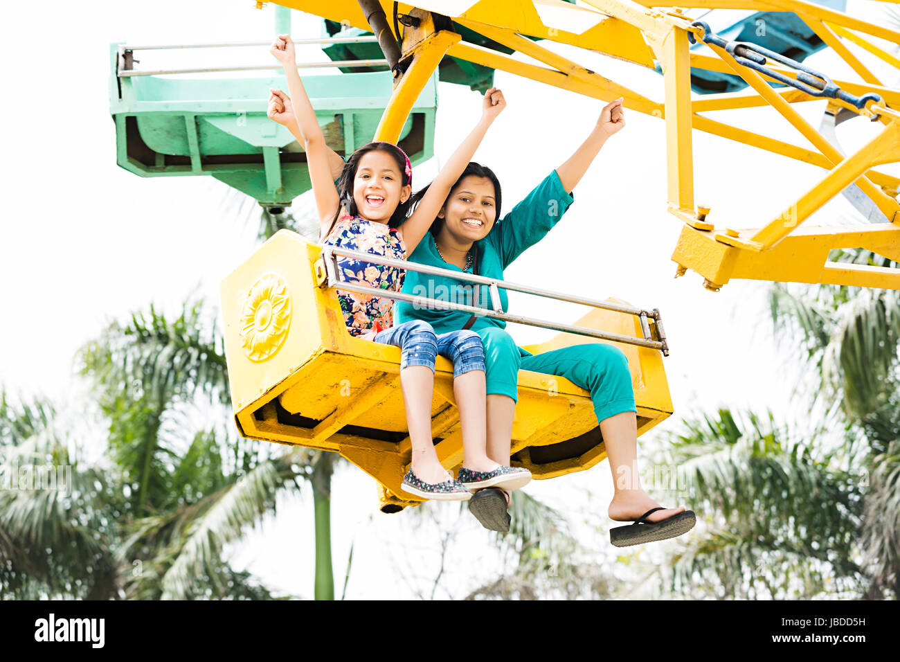 Indian Mother And Kid Daughter Fair Fun Ride Weekend Activities Enjoying Stock Photo