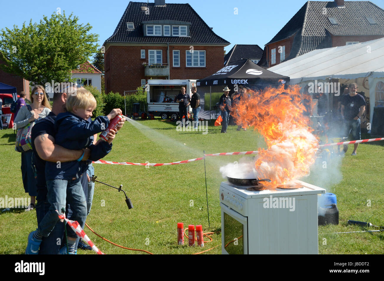 Sonderborg, Denmark - May 26, 2017:  Firemen show off at the arrangement named 'Feuerwehr Sternfahrt 2017'. Even a child can fight a fire, if told how Stock Photo