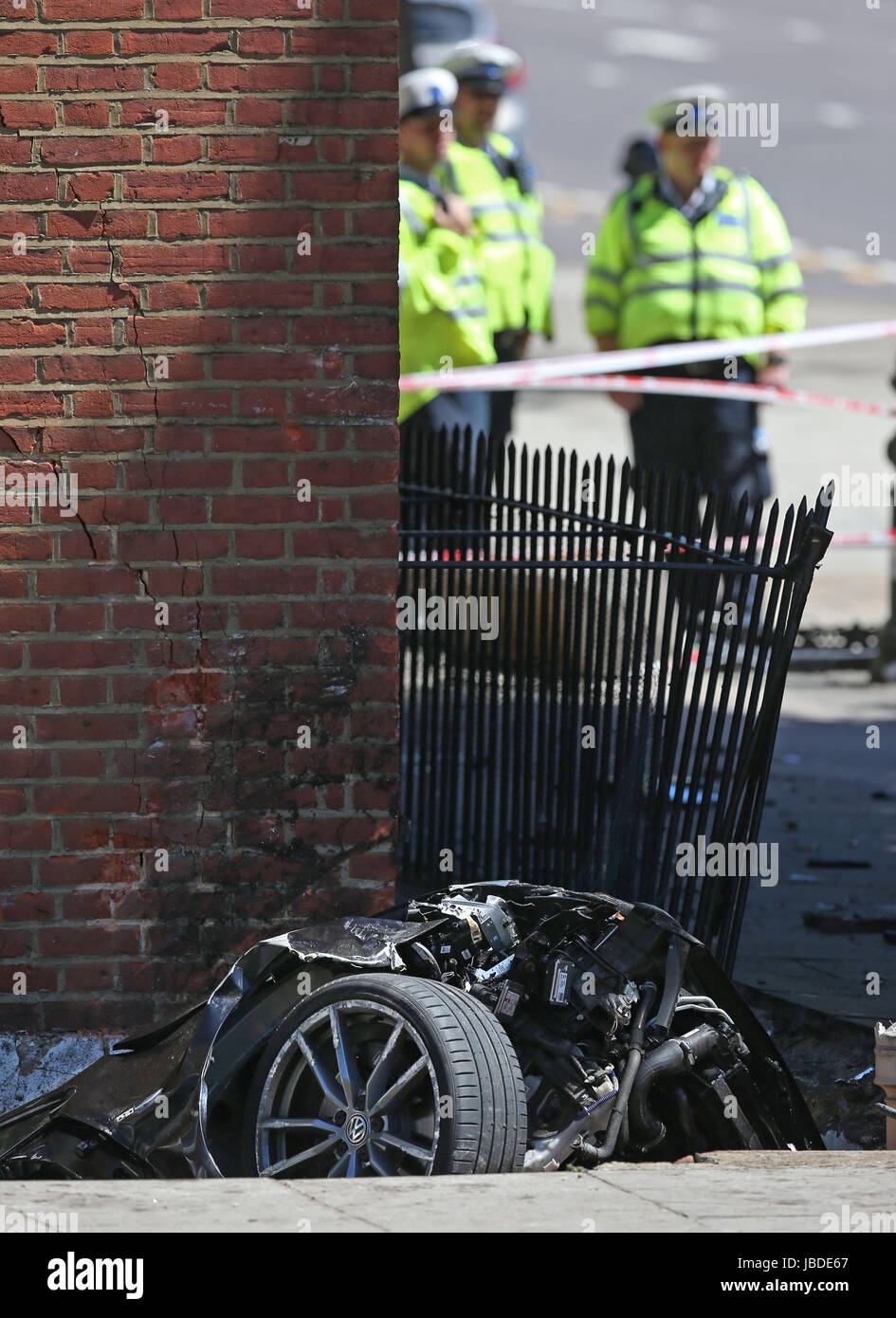 Police at the scene of a car crash in Kensington, London where a man ...