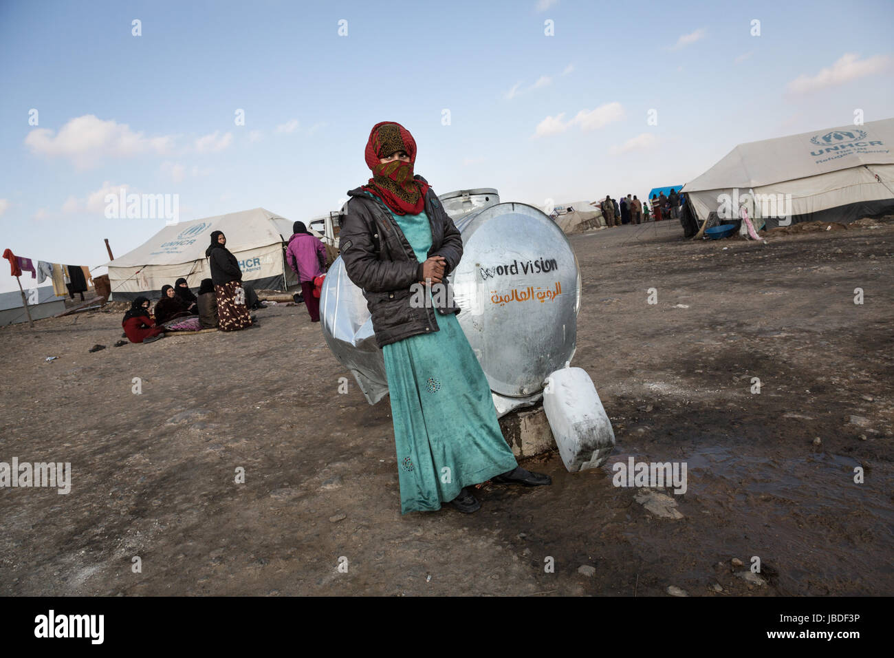 Chris Huby / Le Pictorium -  Syria / Rojava - Wrath of the Euphrates -  04/01/2017  -  Rojava  -  Syria ROJAVA / Dec16 - Jan17. Ain-Issa refugees camp. A woman is filling a pack of water. Stock Photo