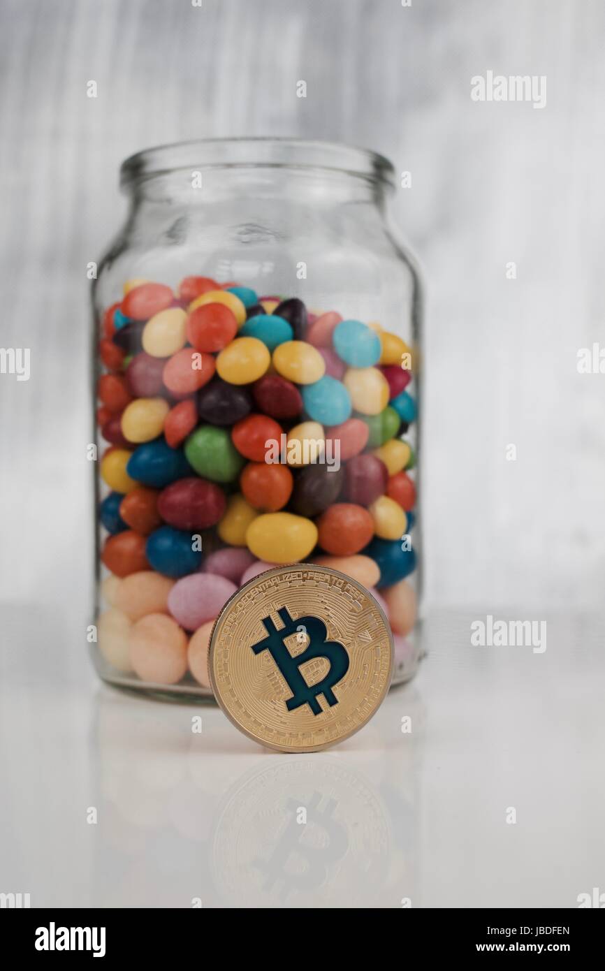 Cryptocurrency physical gold bitcoin coin near jelly sweets in glass jar  Stock Photo - Alamy