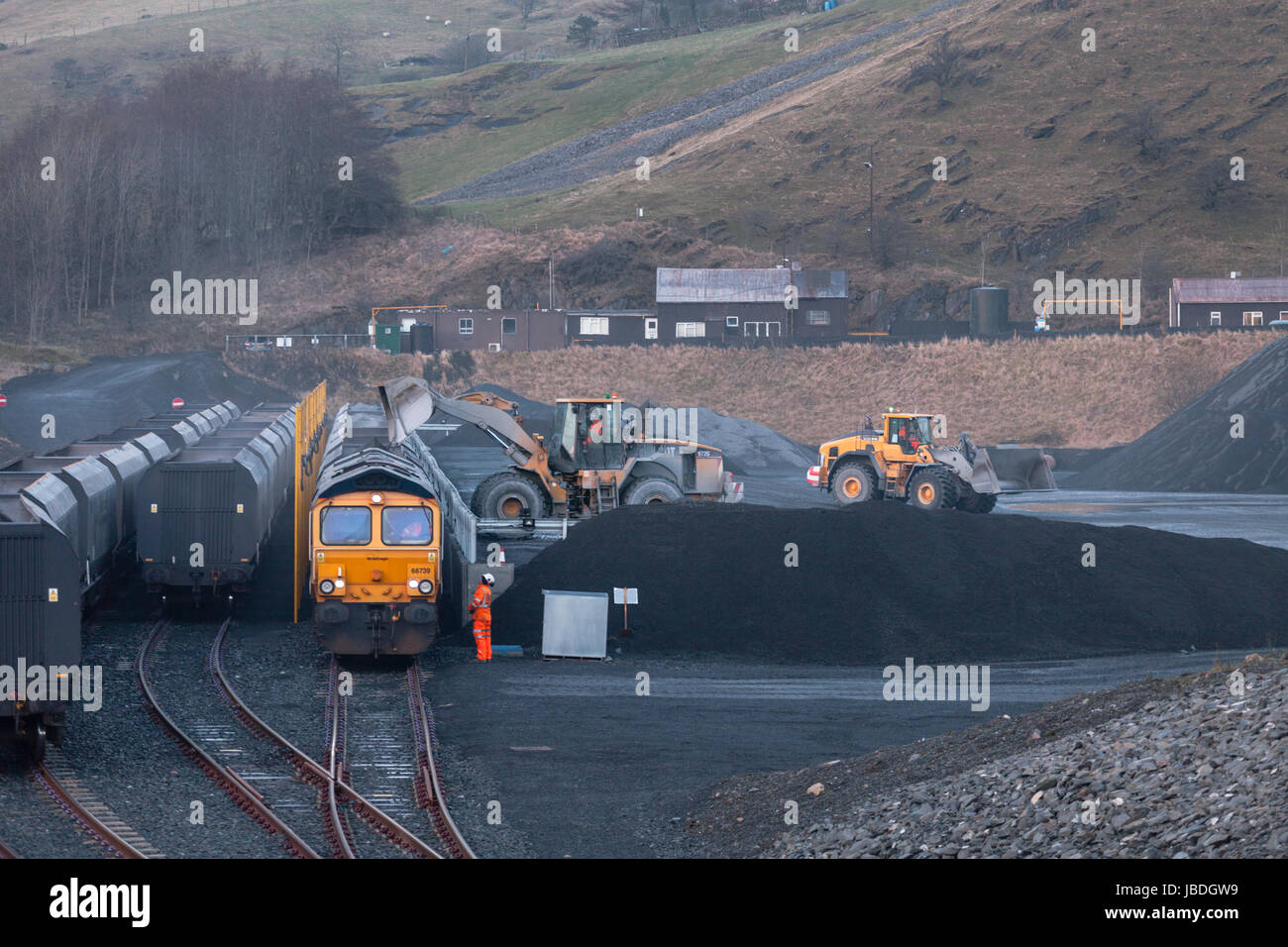 GB Railfreight Class 66 Locomotive waits at Arcow Quarry near Settle while it's trainload of stone is loaded at the quarry Stock Photo