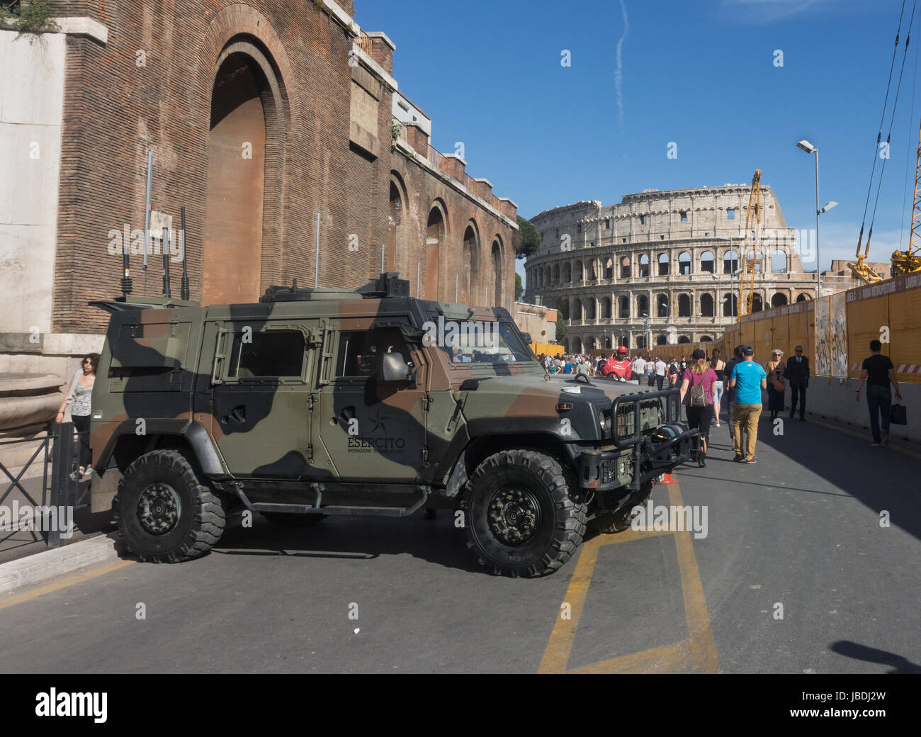 High security on road leading to Colosseum. Military vehicle stationed on busy tourist street; subway construction on right, Rome, May 2017 Stock Photo
