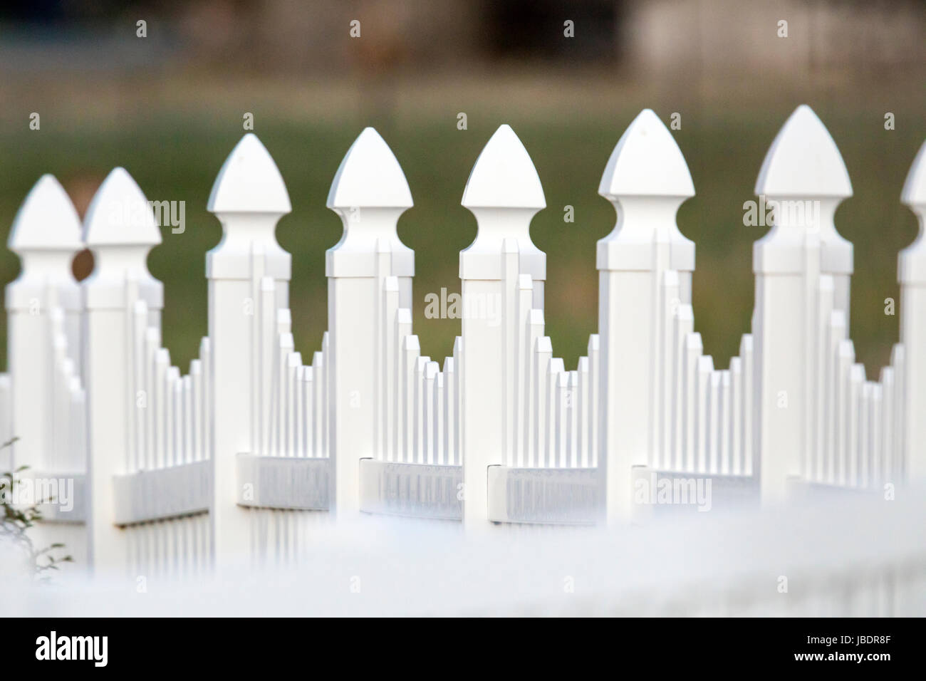 White vinyl picket garden fence in the yard of a Craftsman Style residential home in Colorado, USA Stock Photo