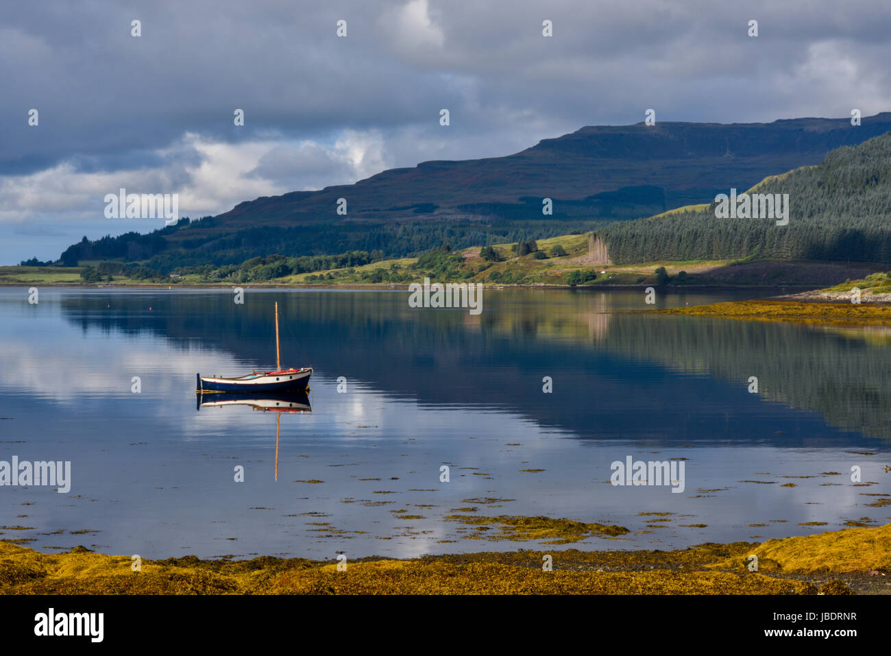 Fishing boat in clear blue water in a scottish loch on Isle of Mull. Argyll and Bute, Scotland, United Kingdom Stock Photo