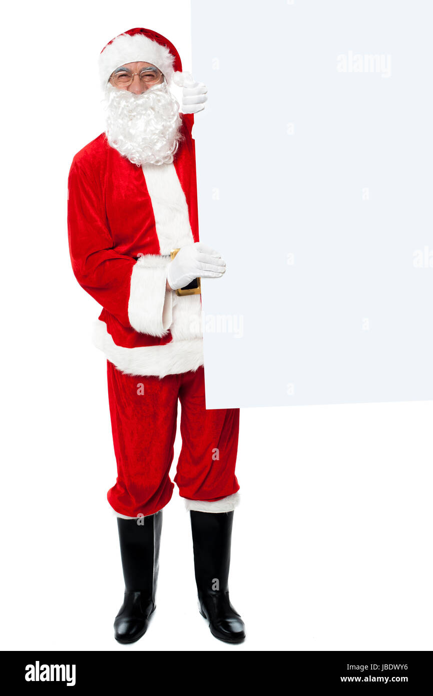 Santa claus holding blank whiteboard Stock Photo - Alamy