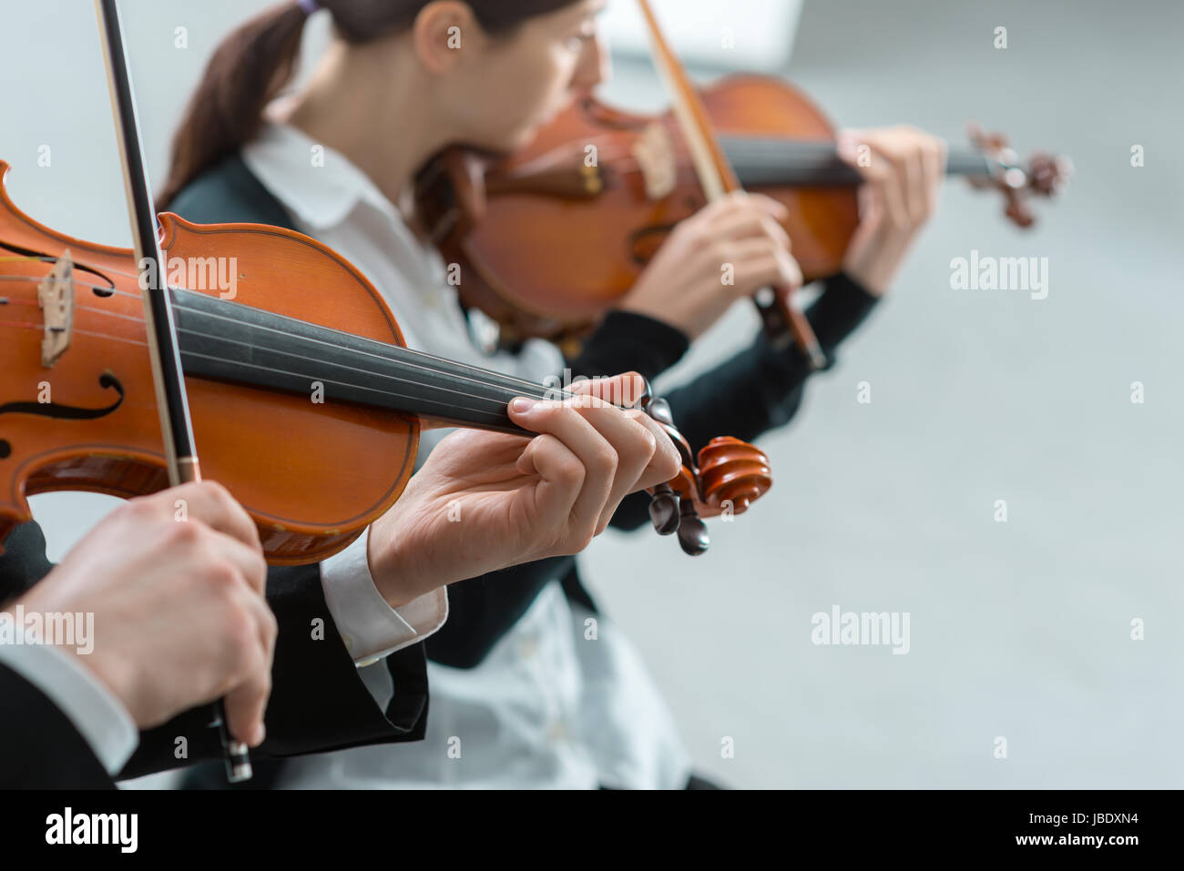 Two violinists performing together hands close up, classical music