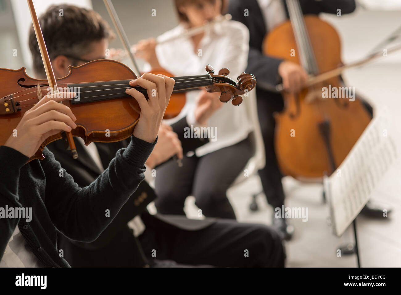 Classical music symphony orchestra performing on stage, professional