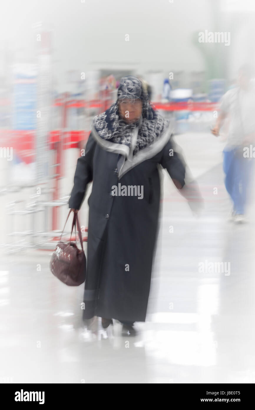 Turkish old woman walking in the airport Stock Photo