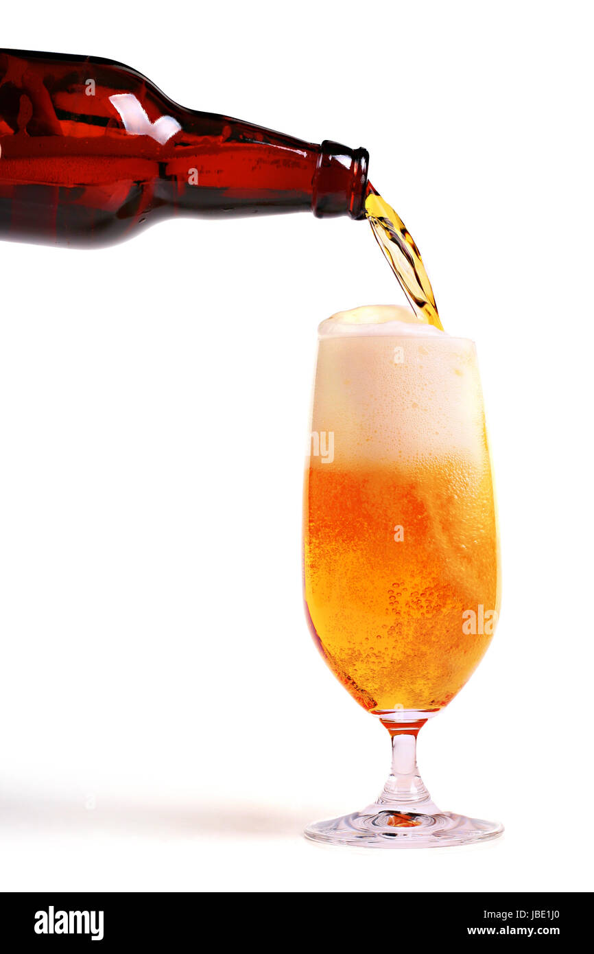 Beer pouring from bottle into glass isolated on white background Stock Photo Alamy