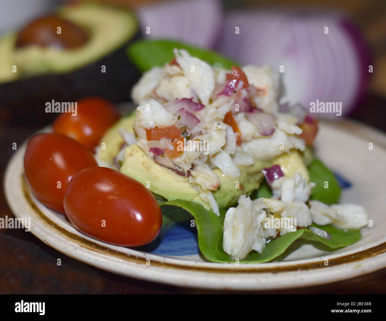 Three grape tomatoes embellish a crab meat salad. Stock Photo