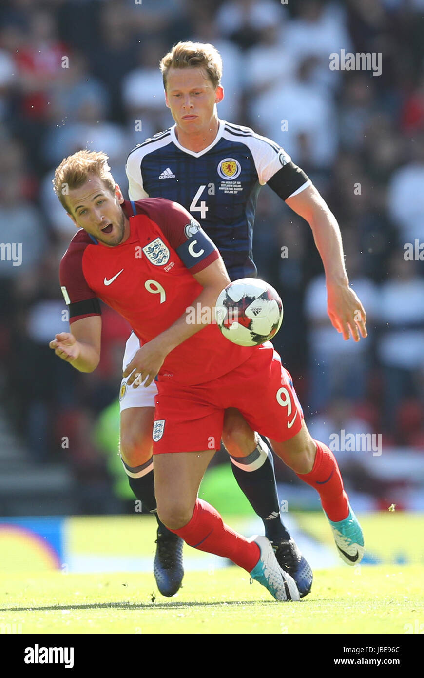 England's Harry Kane (left) is fouled by Scotland's Christophe Berra during the 2018 FIFA World Cup qualifying, Group F match at Hampden Park, Glasgow. Stock Photo