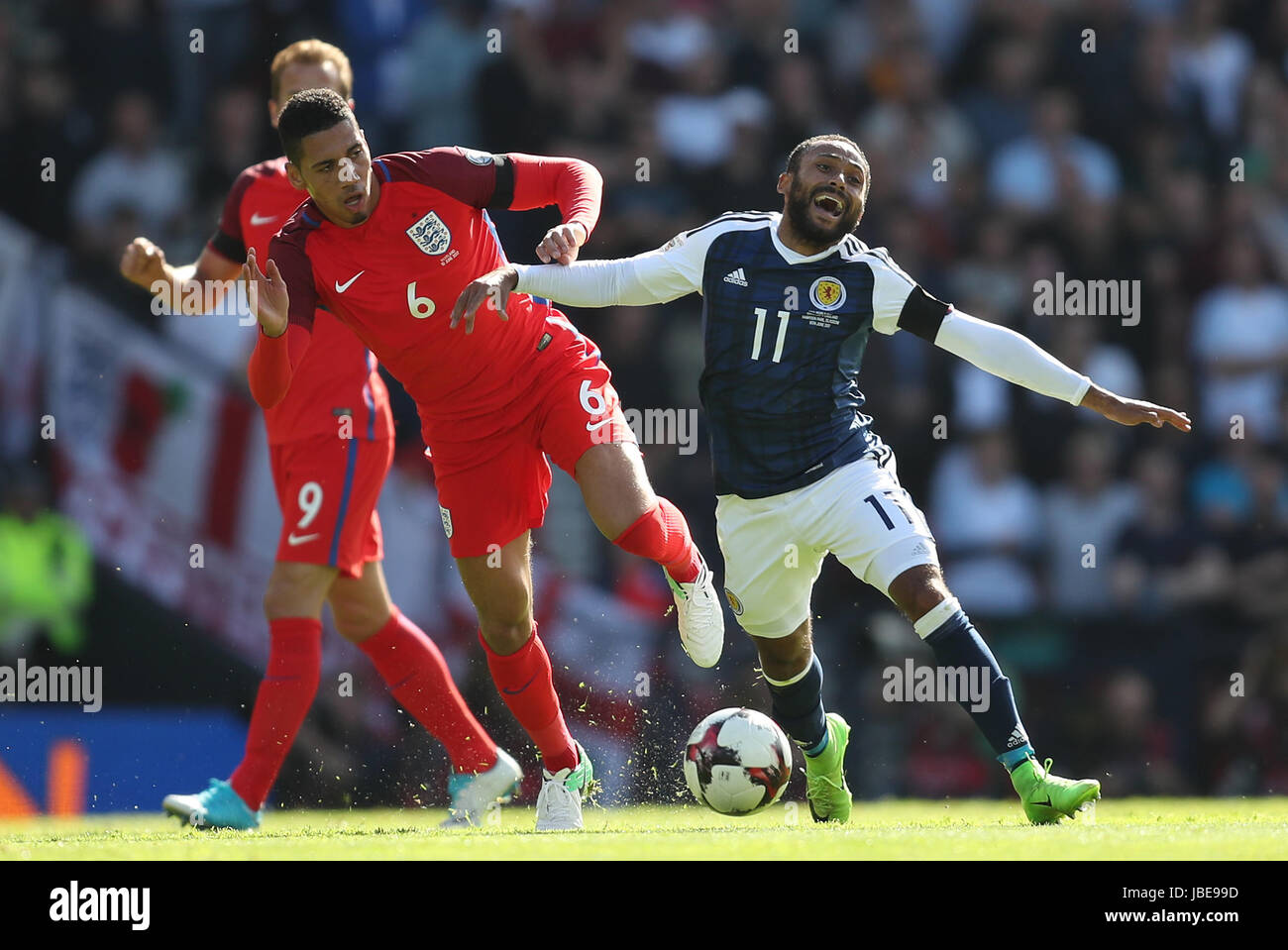 England's Chris Smalling (left) and Scotland's Ikechi Anya battle for the ball during the 2018 FIFA World Cup qualifying, Group F match at Hampden Park, Glasgow. Stock Photo