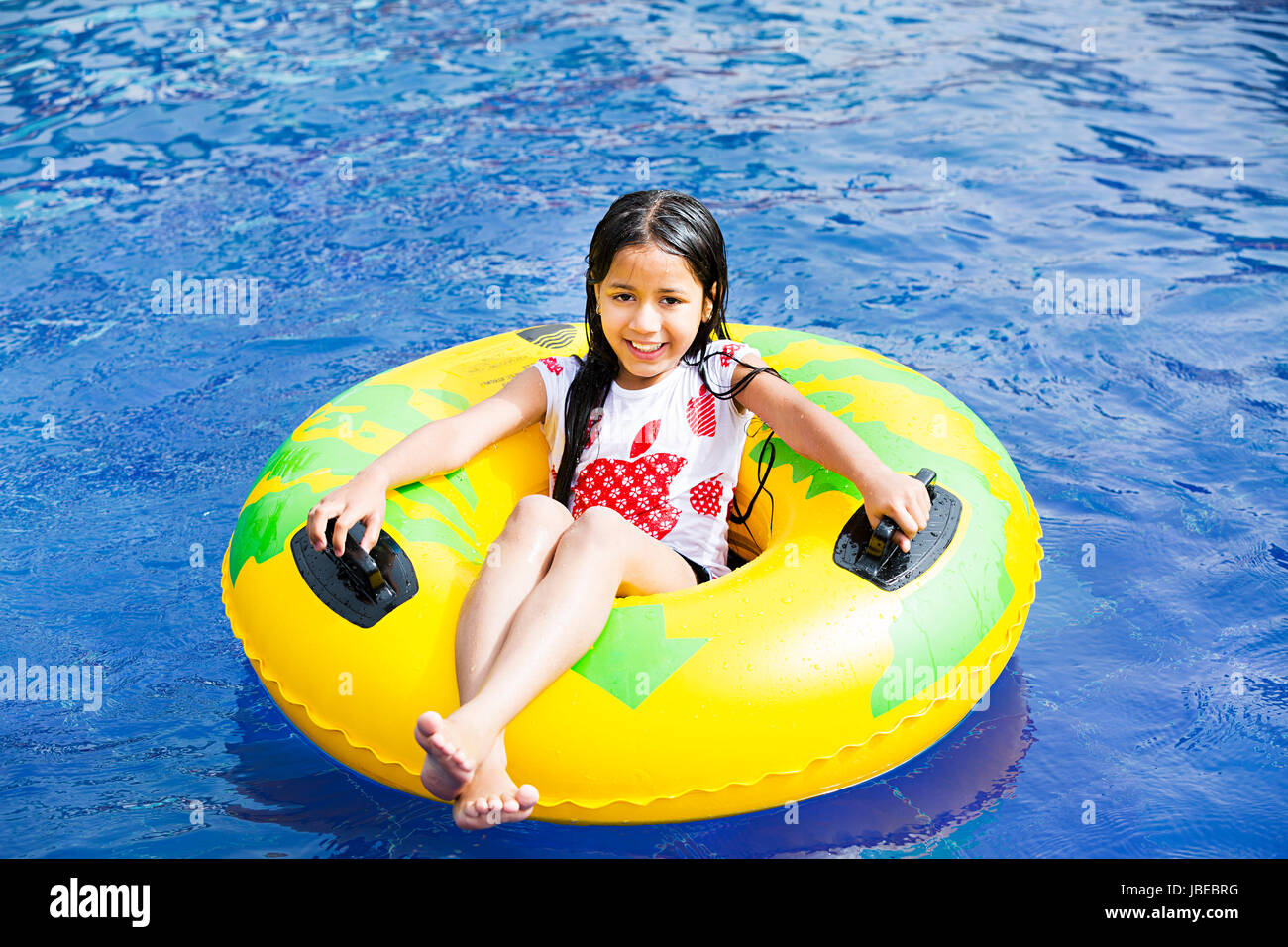 Happy 1 Indian Little girl relaxing inflatable ring resort pool Smiling  Stock Photo - Alamy