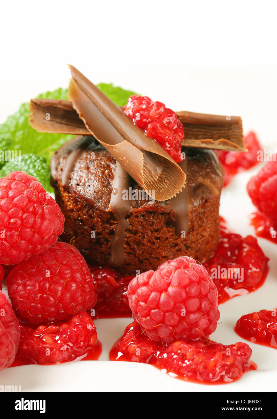Mini chocolate cake served with fresh raspberries Stock Photo - Alamy