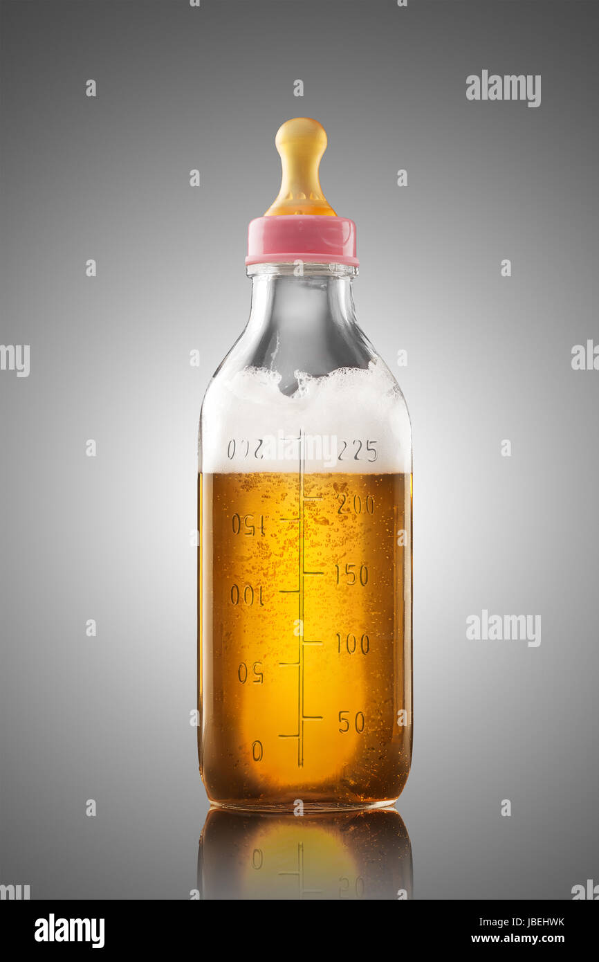 A feeding bottle with nipple full of beer as a milk replacement for