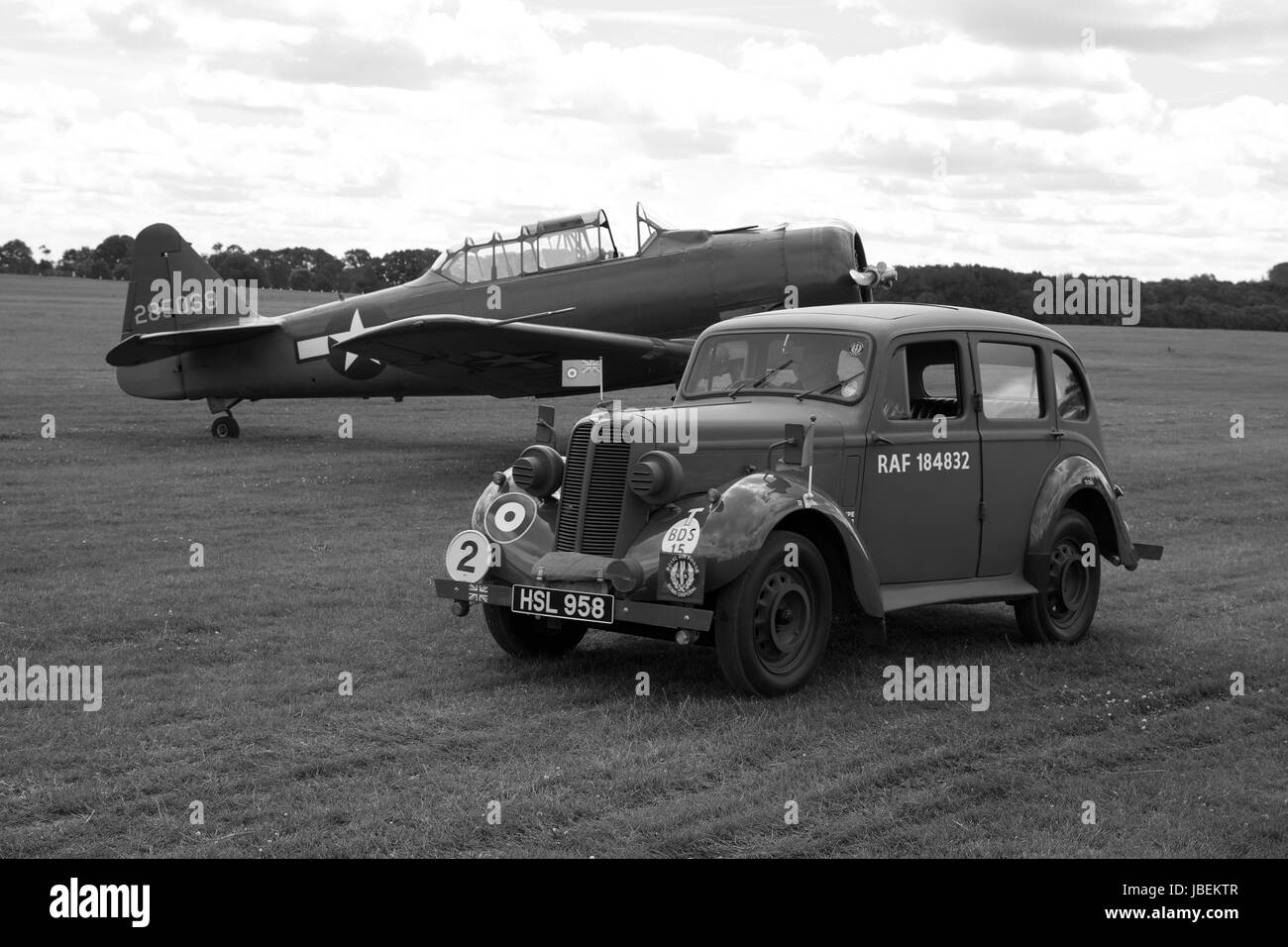 1938 RAF Hillman Minx staff car with a North American Harvard in the back ground Stock Photo