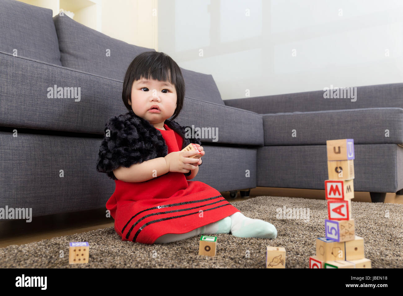 Asian baby girl play toy block at home Stock Photo - Alamy