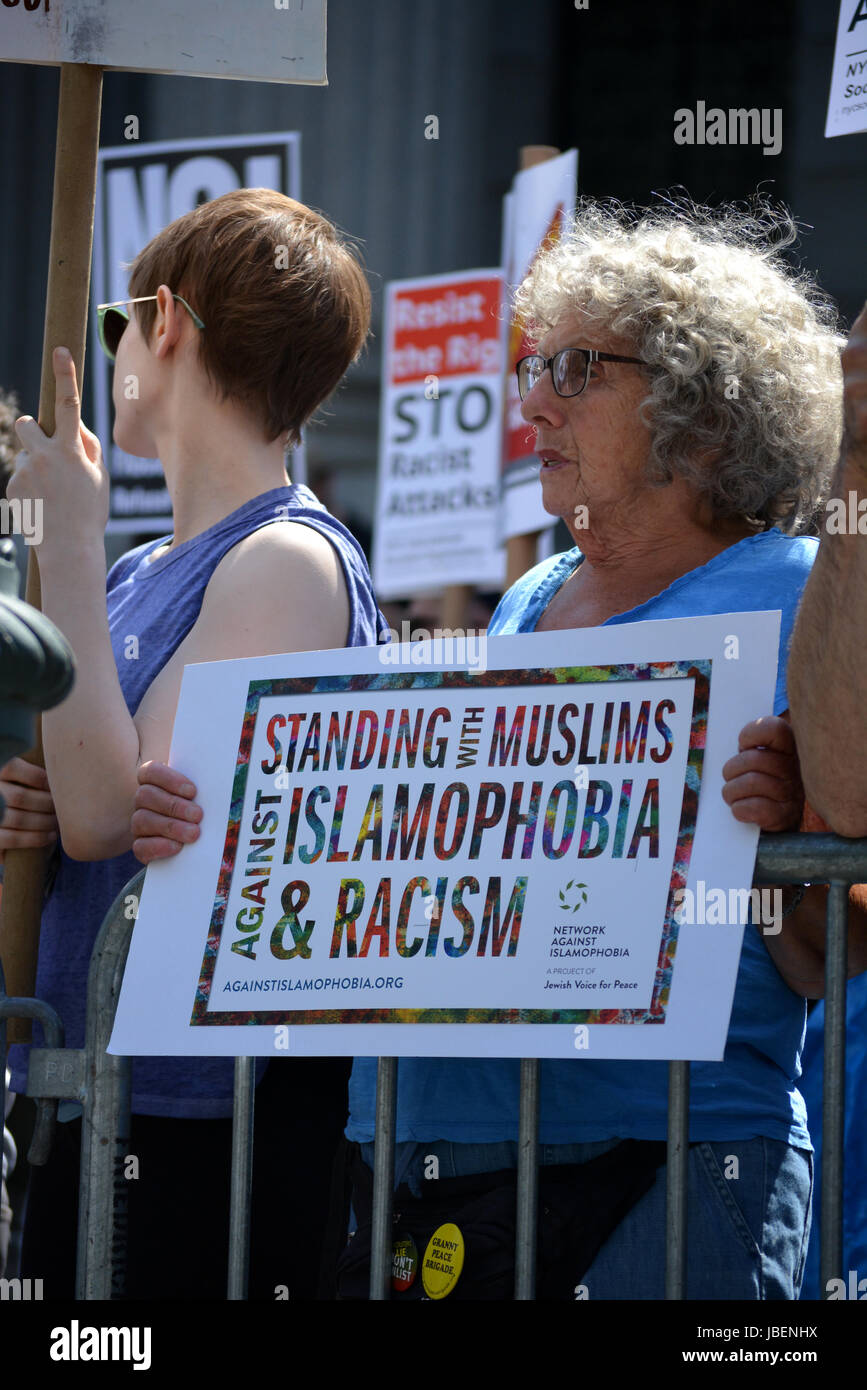 People holding signs supporting Islam at a counter protest to an anti-Sharia rally in New York City. Stock Photo