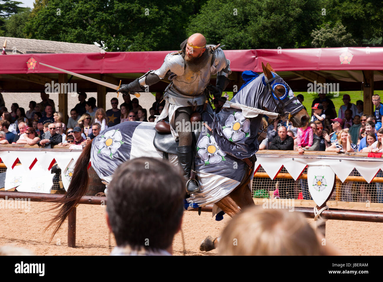 War of the Roses jousting battle re-enactment performed in front of an audience of tourists at Warwick castle in Warwickshire. UK. (88) Stock Photo