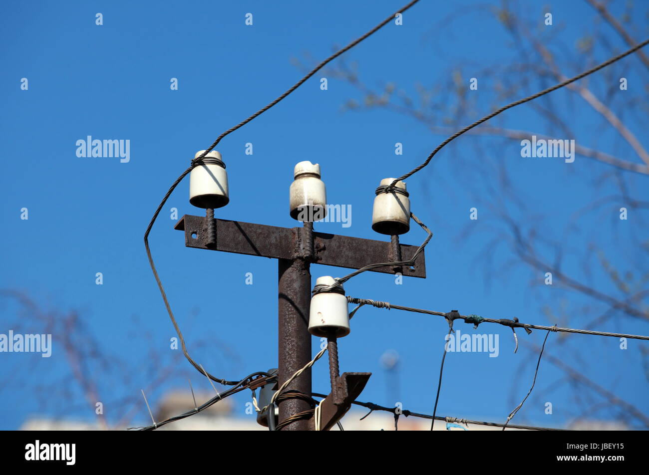 electrical wires on a background of blue sky Stock Photo