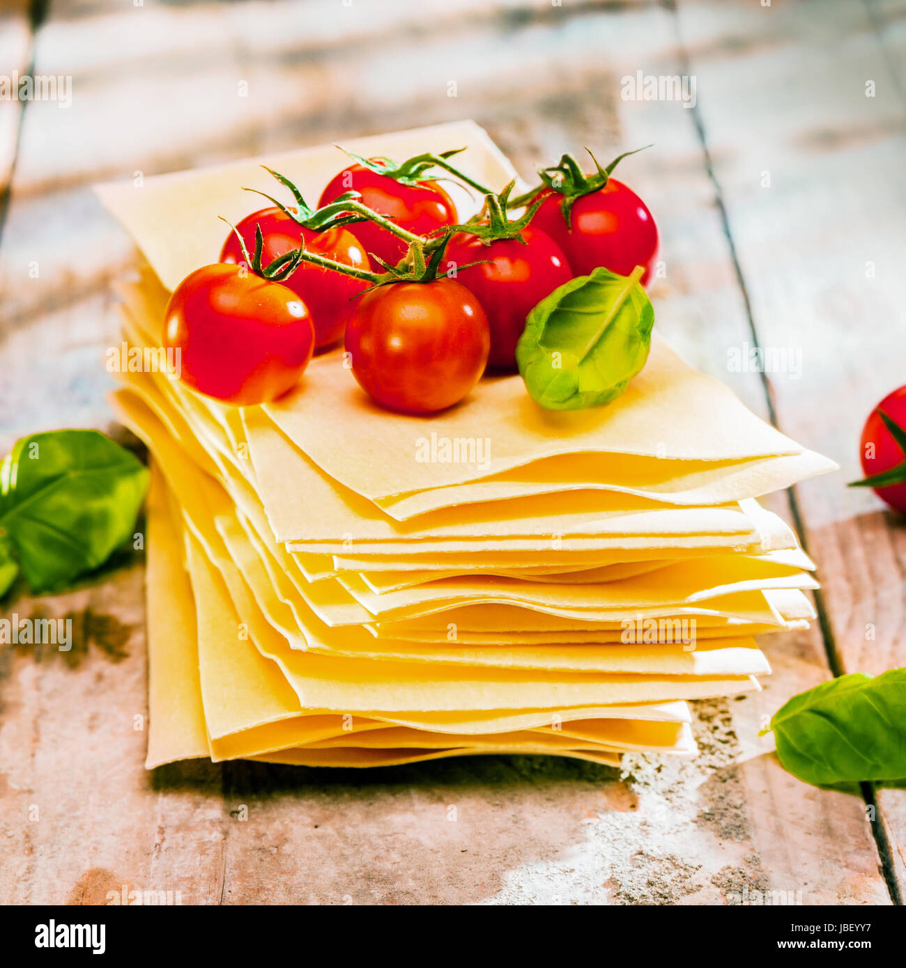 Dried uncooked lasagne pasta sheets with fresh ingredients including