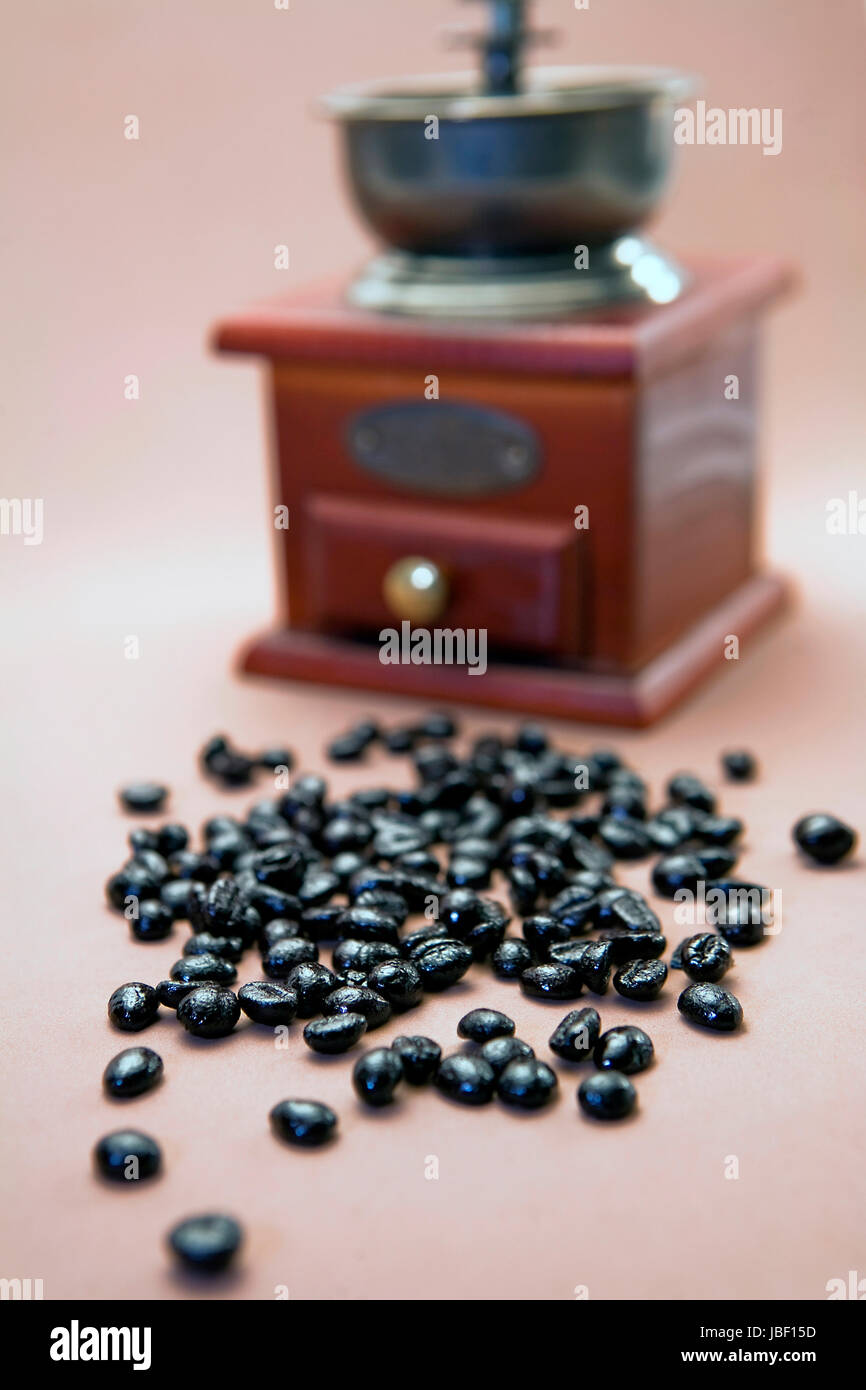 Roasted coffee beans are ground in a coffee grinder Stock Photo - Alamy
