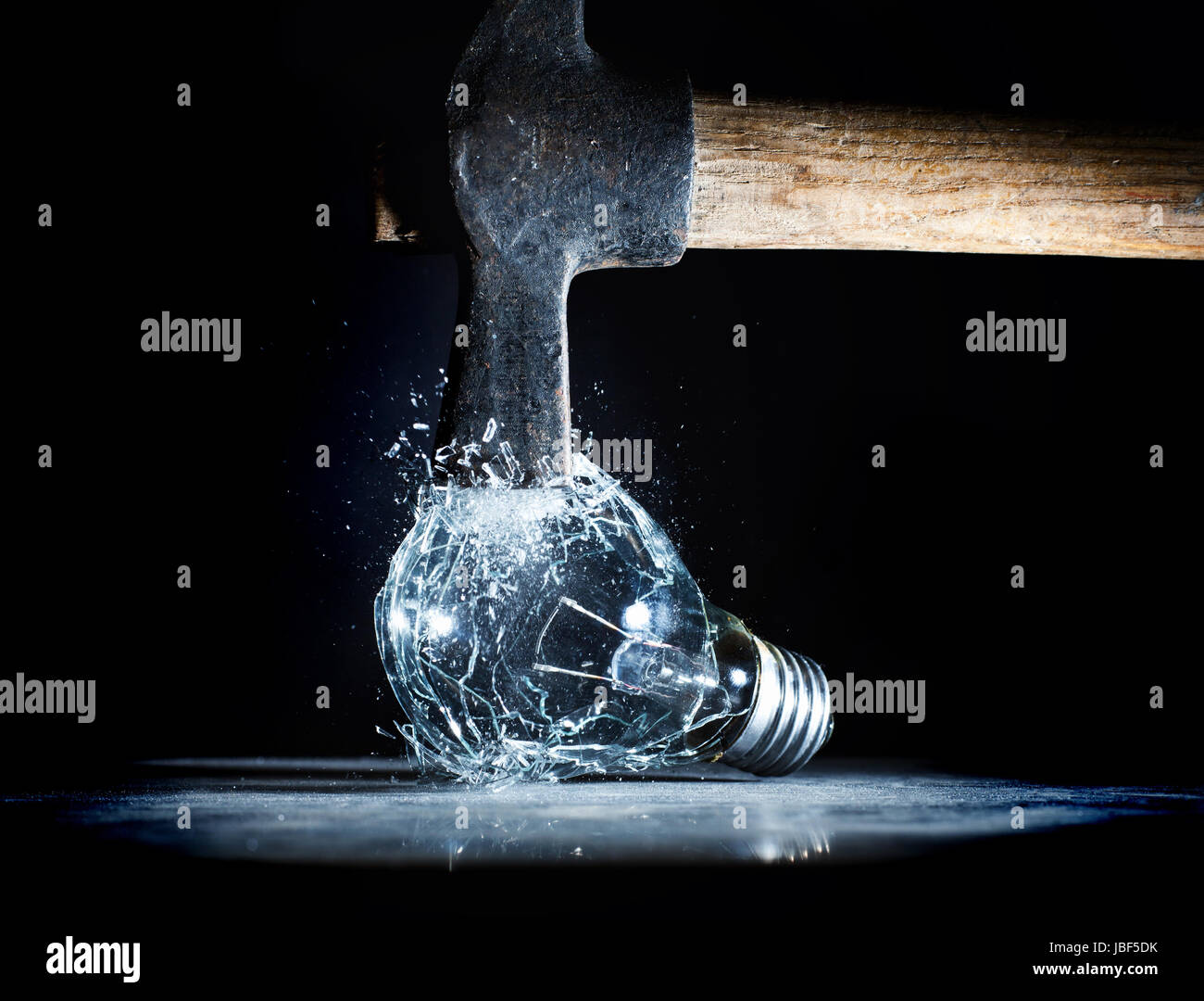 hammer tool destroy electric bulb high speed photo Stock Photo