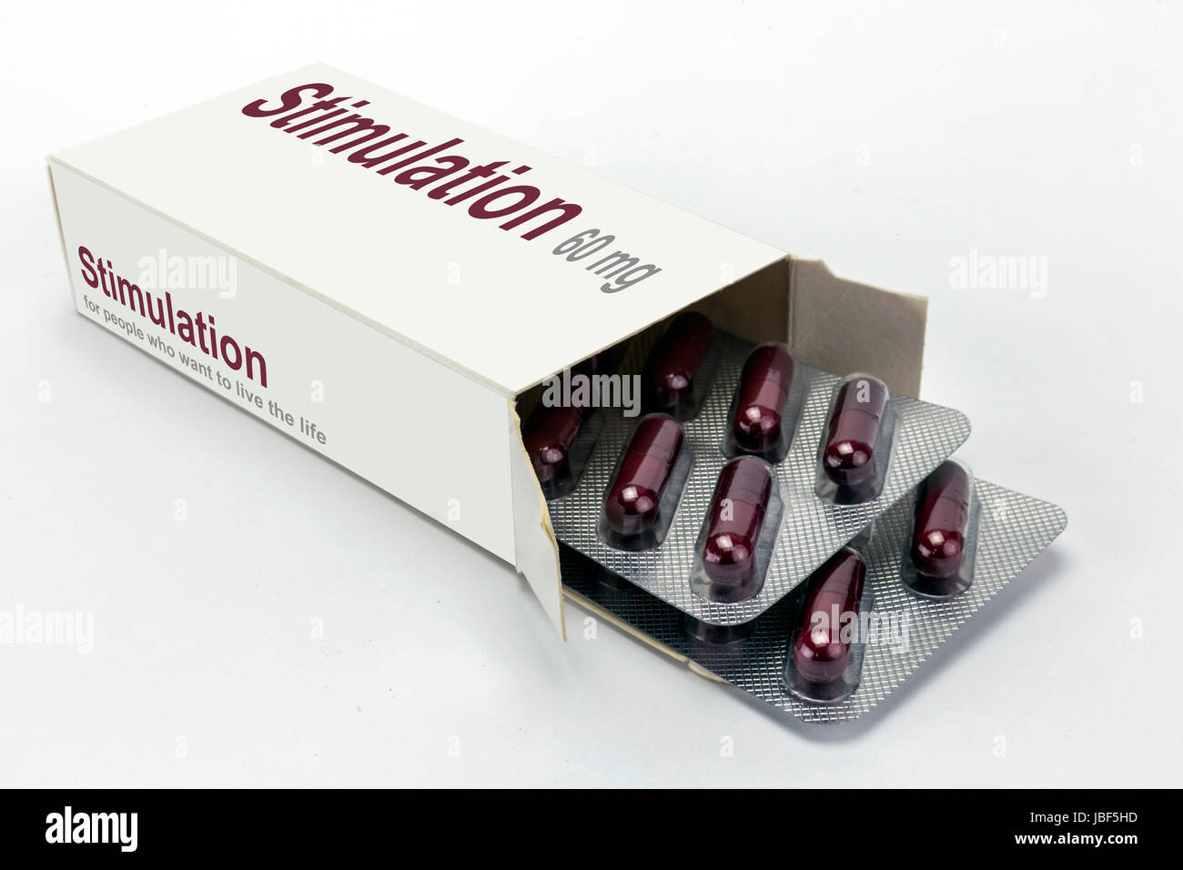 Open medicine packet labelled stimulation opened at one end to display a blister pack of tablets, isolated on white Stock Photo