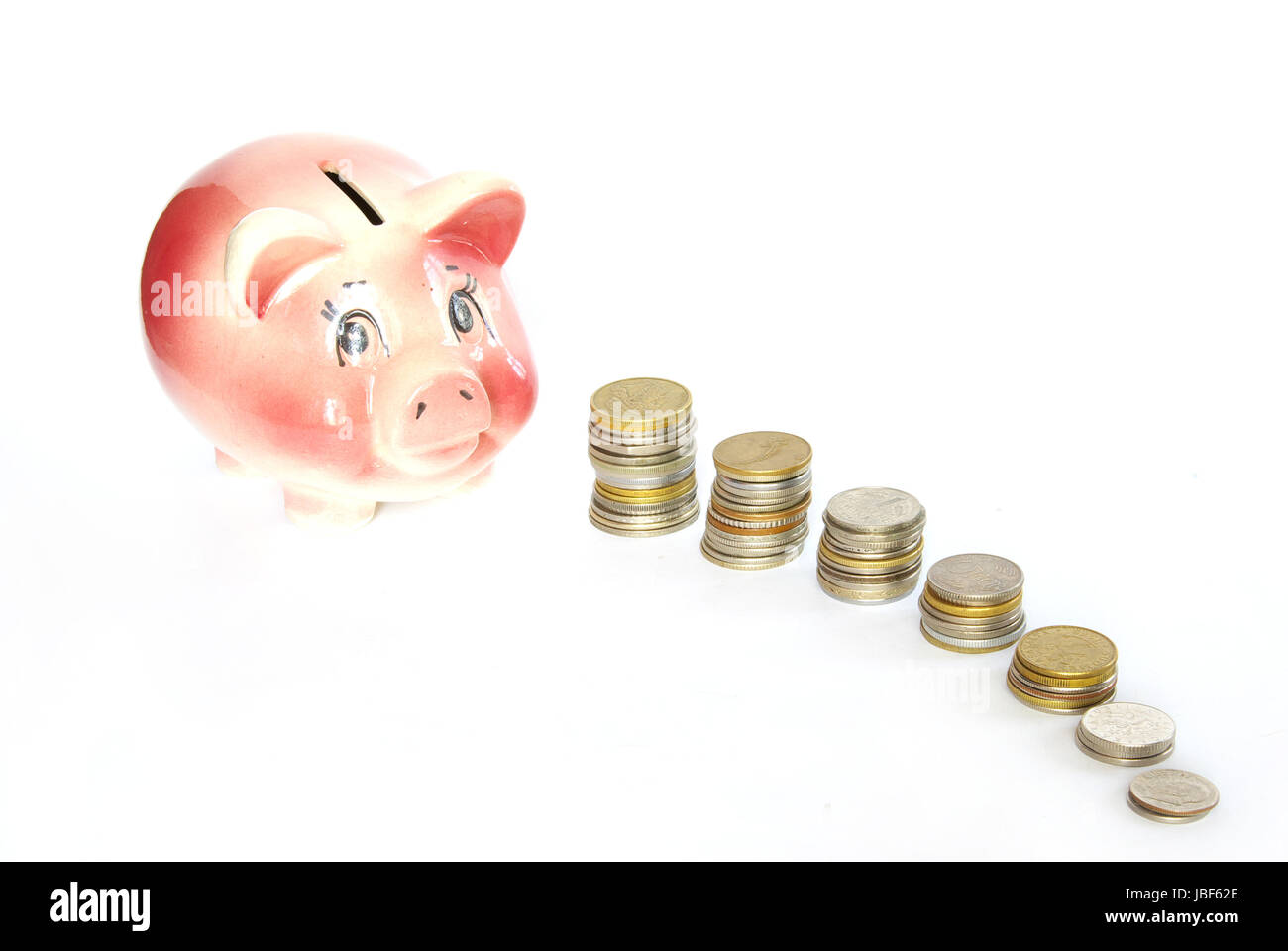 Pink piggy bank isolated on white background with coins Stock Photo - Alamy